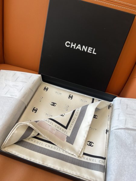 Chanel 25P Bow Scarf White. 90x90cm, 100% silk. Soft, elegant, iconic logo with bow design. Versatile for casual or formal wear.
