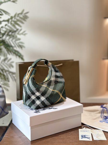 Burberry's latest Peg tote bag. Soft, structured Italian knit with iconic check pattern. Lightweight, unlined design. Clasp clip features engraved logo. 20cm.