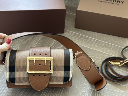 Burberry plaid buckle bag with adjustable strap. Compact yet spacious, fits phone, makeup, keys. Versatile and stylish for all seasons.