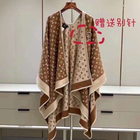 Louis Vuitton Embrace cape, 137x152cm. 70% wool, 20% silk, 10% cashmere. Features monogram jacquard and LV Circle clasp.