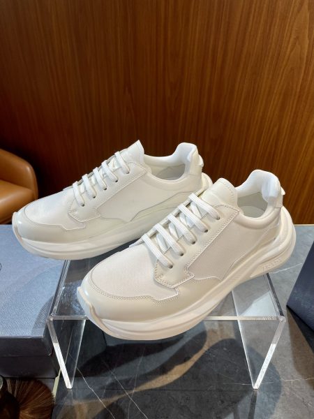 Prada men's platform sneakers, sizes 39-44. Hidden laces, hand-stitched details, lightweight sole with 6.5cm height increase. Modern classic design.