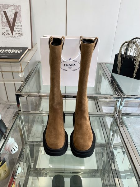 Prada 24ss classic triangle logo women's boots. This winter's must-have, stunning design. Made from various imported materials: waxed calfskin, patent calfskin, cow suede, and dyed sheepskin lining. Lightweight foam sole. Sizes 35-41.
