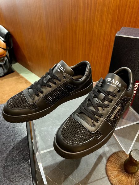 PRAD* crystal sneakers in calfskin, sizes 38-45. Features sparkling details, enamel triangle logo, and lettering on tongue and rubber sole.