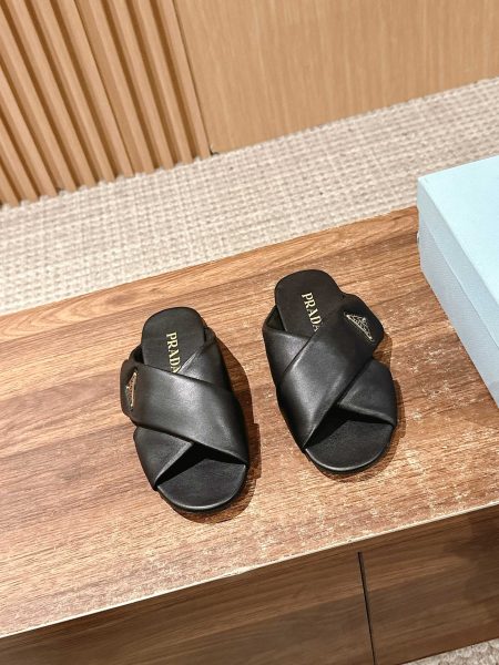 Prada 2025 SS flat sandals with cross design and triangle logo. Lambskin upper, rubber sole. Sizes 35-39.