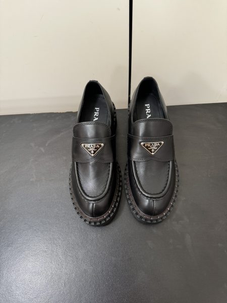 Prada Fall/Winter 2024 platform loafers with triangle logo. Made from imported calfskin and lambskin, featuring a 5cm anti-slip sole. Sizes 35-40.