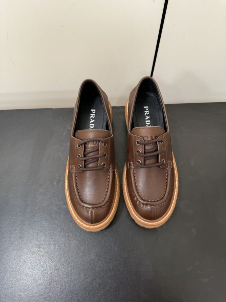 Prada lace-up leather shoes with minimalist design. Features metallic logo, 5cm heel, and foam rubber sole. Sizes 35-39.