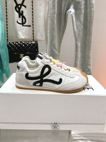 LOEWE's new Ballet Runner 2.0 sneaker features an asymmetric toe, soft leather lining, wave-textured rubber sole, and retro design. Materials: nylon/suede and soft calfskin. Sizes: 35-45.