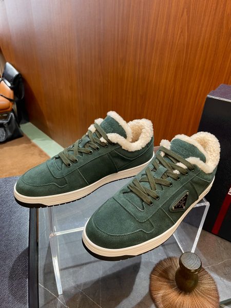 PRADA suede sneakers with shearling lining, sizes 38-45. Features warm fabric, lightweight rubber sole, embossed and enamel logos.