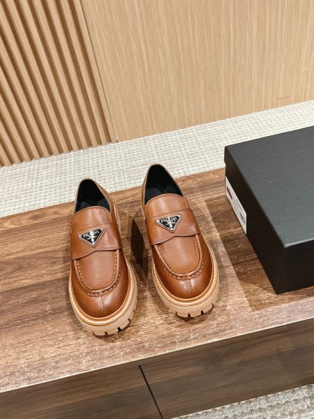 Prada platform leather loafers, retro style with triangular logo. Imported calfskin upper, sheepskin lining, 4cm rubber sole. Sizes 35-40.