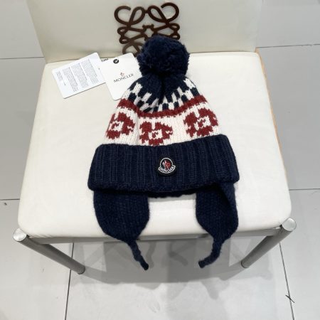 Original Moncler Nordic-style knitted hat with ear protection and pom-poms.